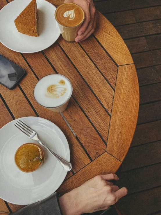 a table with white plates and three different desserts on it