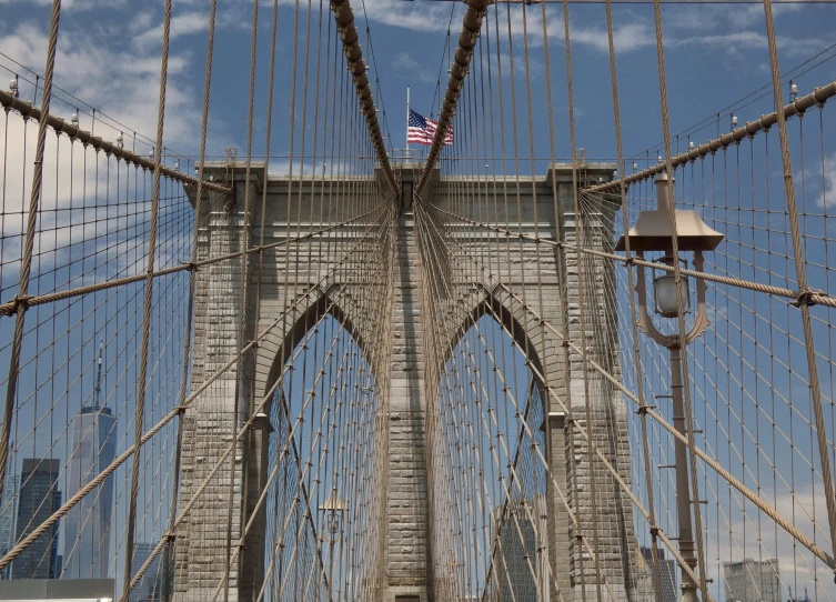 an open bridge over water with many wires