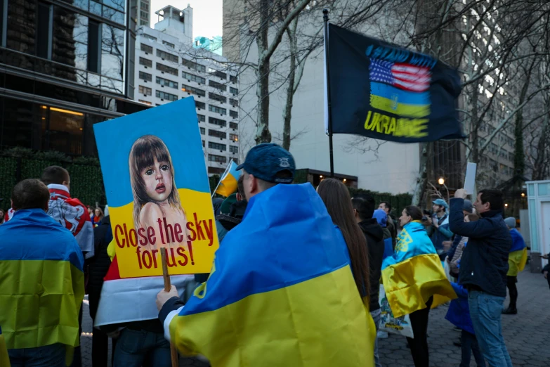 a group of people holding yellow and blue banners