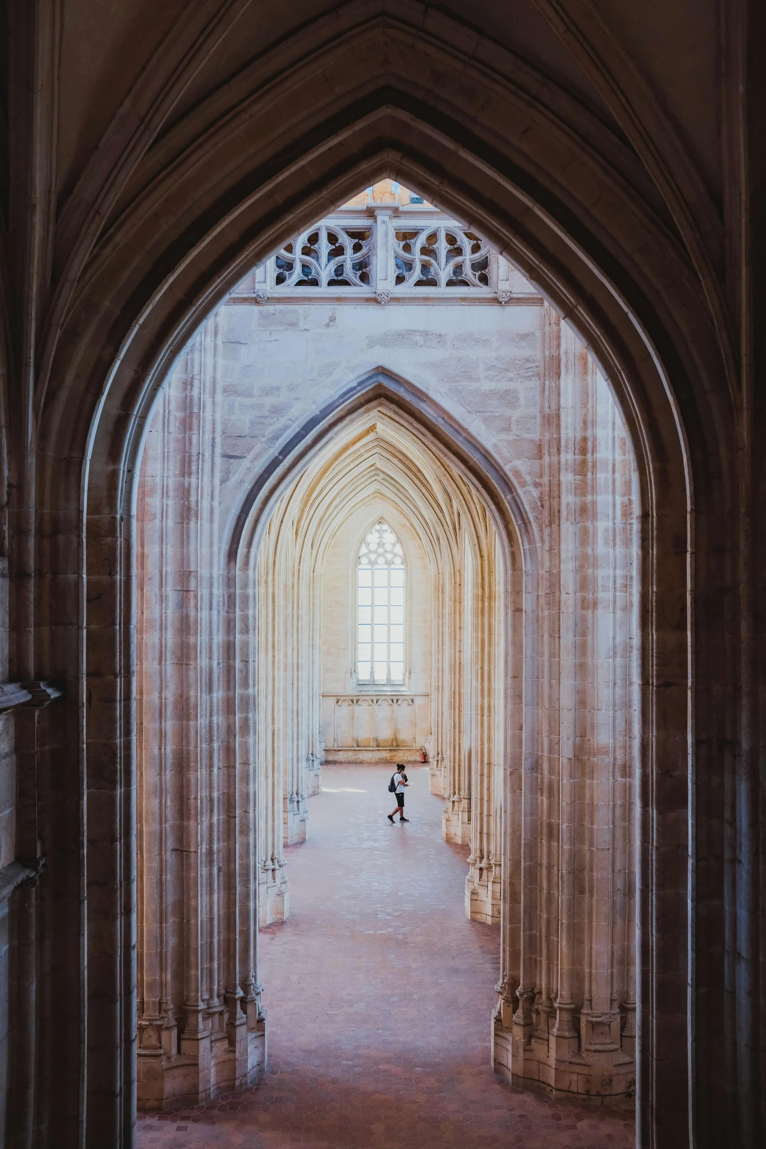 a little boy sitting on the floor in an archway