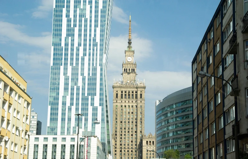 this is a city with tall buildings, street lights, and tall clock tower