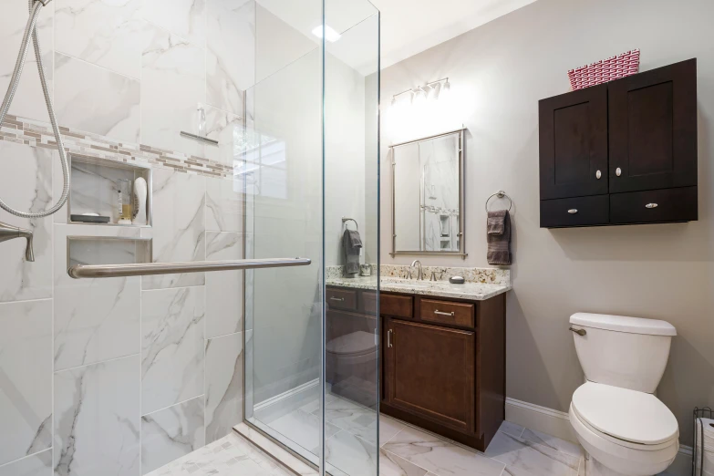 a toilet, sink and shower in a room