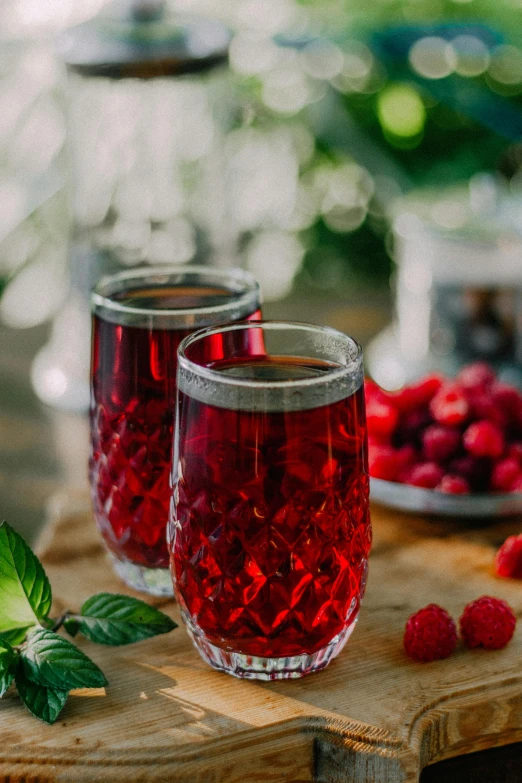 two glasses with fruit in them sitting on a table