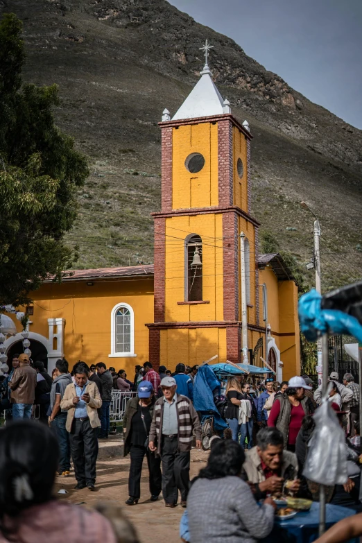 many people walk near a small church