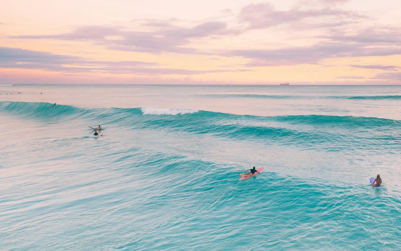 people are surfing on the blue ocean waves