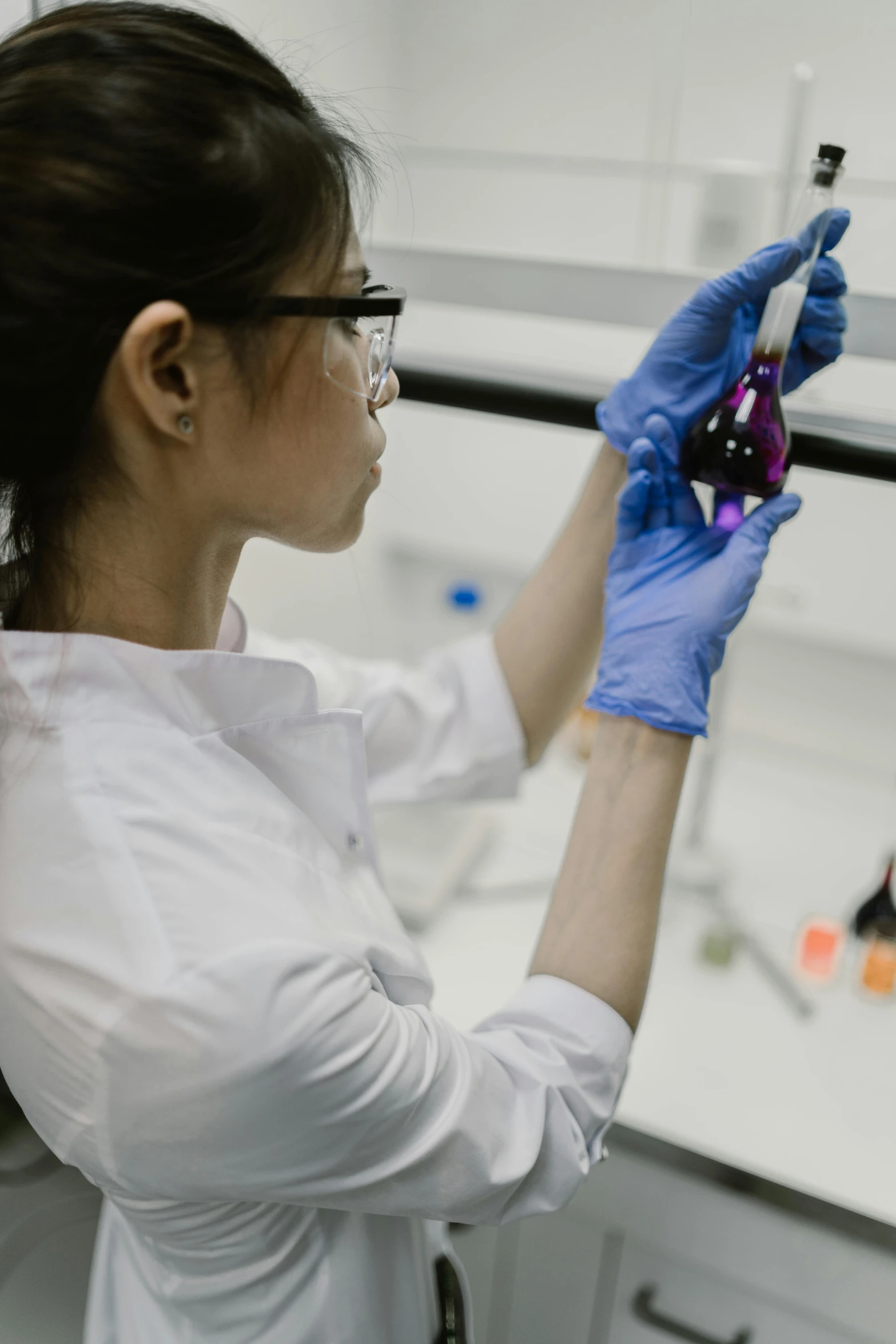 a woman working with an item in a lab