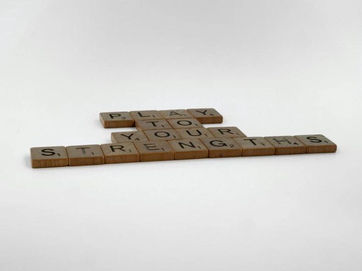 three scrabble tiles arranged in the shape of a rectangle