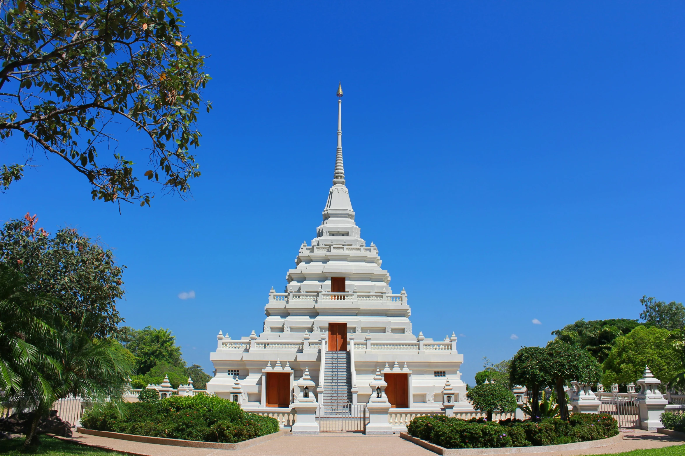 a tall tower structure sitting next to lush green trees