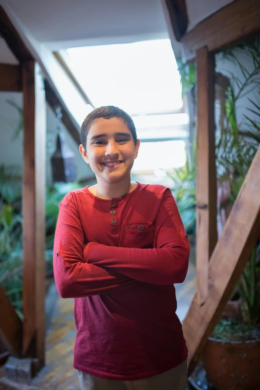 young man in a red shirt posing for a portrait