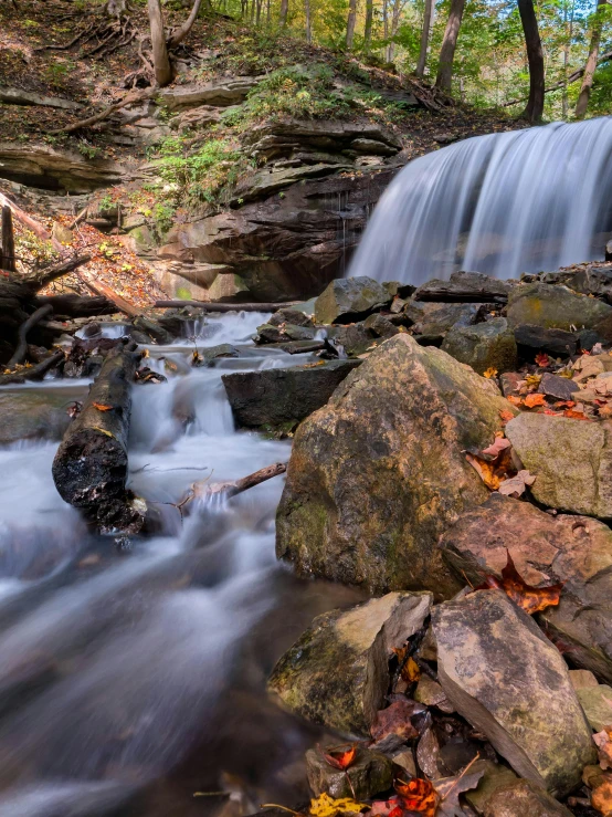 a waterfall flows in the middle of a rocky creek