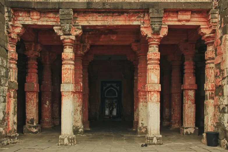 two large pillars sitting inside of a brick building