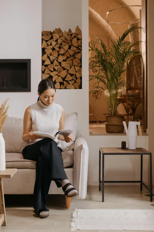 woman sitting on white couch in white living room