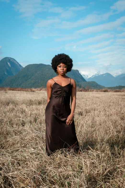 a woman is standing in an open field