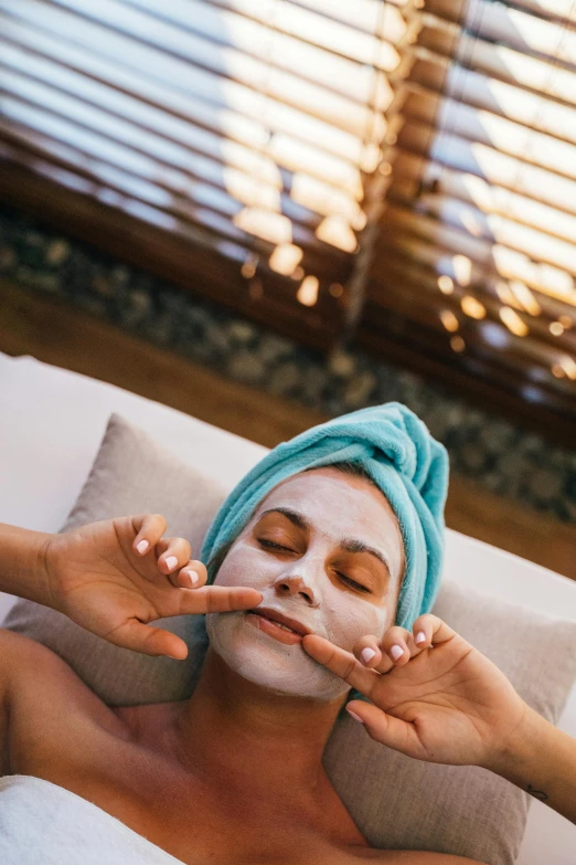 a man has his face covered by a towel