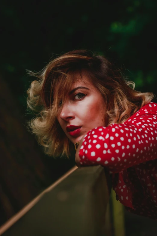 a woman is leaning on the wall and posing