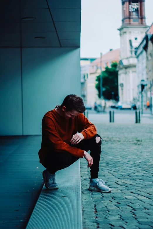 a man squatting and taking a moment to rest