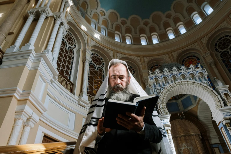 a man with long white hair is reading