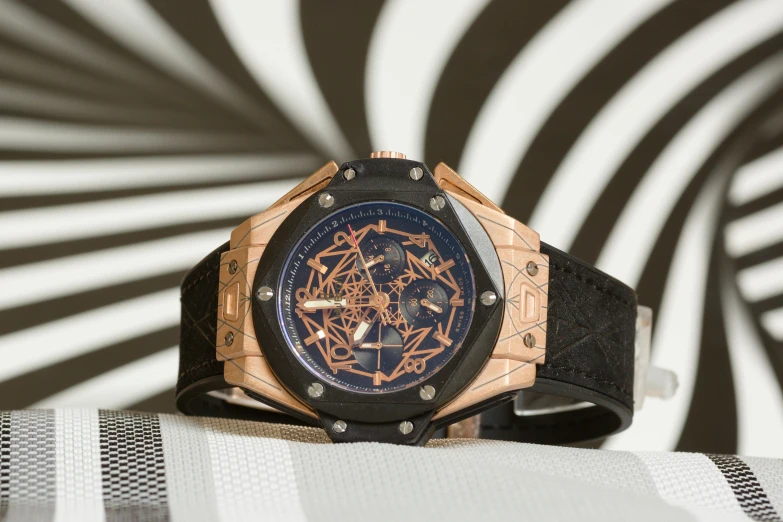 the watch on display in front of a ze striped background