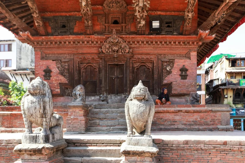 two statues sitting in front of a building