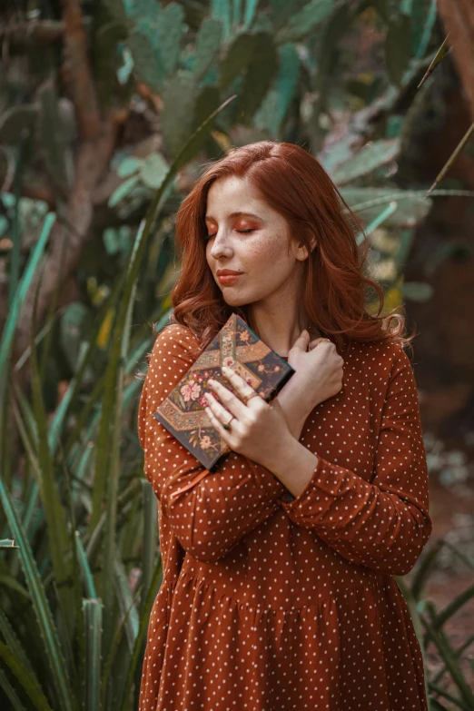 the young woman has her hand under her face