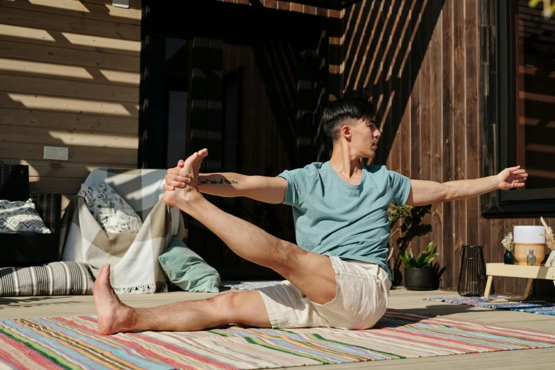 a man sitting on his back in a yoga pose