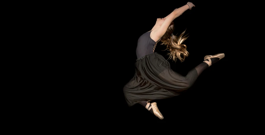 woman doing a flip in the air at night