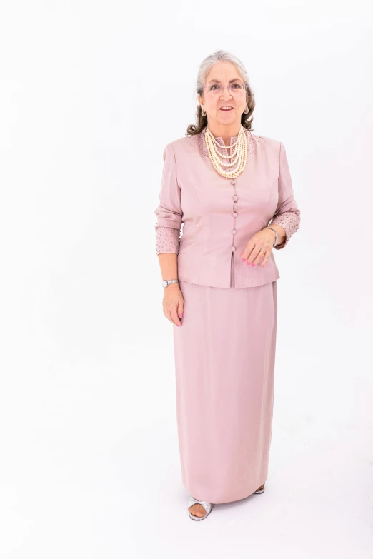 an older woman wearing a pink dress