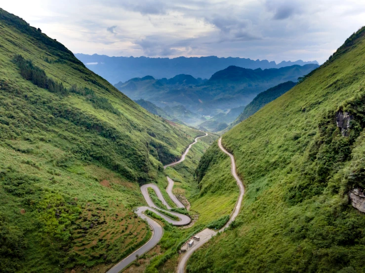 an image of two roads winding up the side of mountains