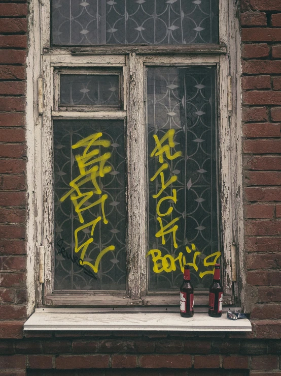 graffiti on window of brick building with double doors