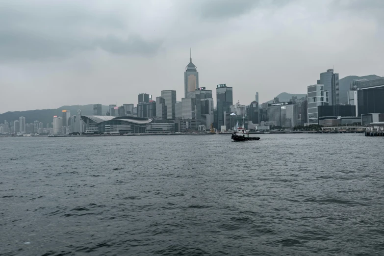 cityscape with a boat in the water and buildings in the distance