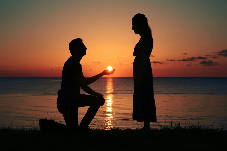 a woman is touching the finger of a man standing next to her