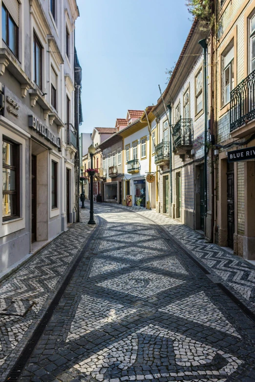 a cobblestone street between two building type buildings