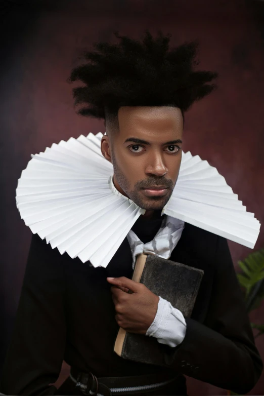 a man with hair tied in a fan like way and reading