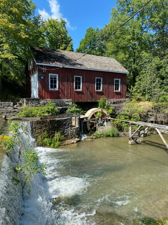 the red house sits on the edge of the river