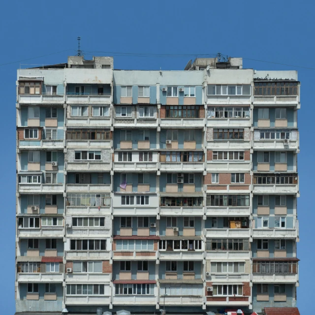 an apartment building is in front of a blue sky