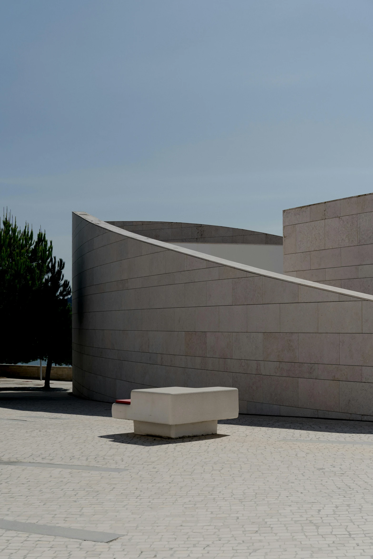 large cement sculpture in front of large concrete building