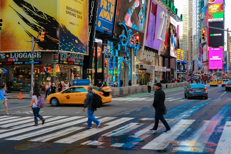 a busy intersection in an downtown city with people walking