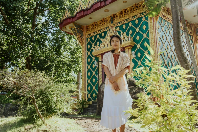 a woman standing in front of a small building