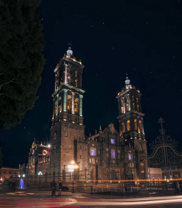 the night lights of the building and trees illuminate the old architecture