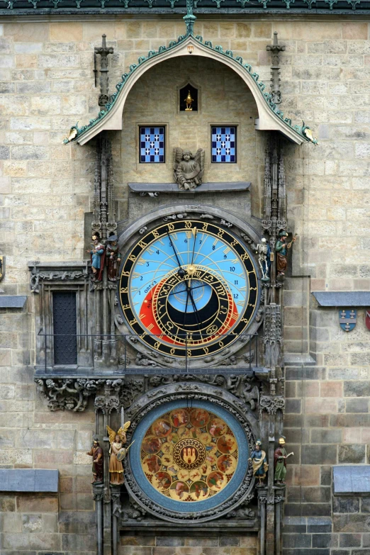 two large clocks mounted to the side of a building