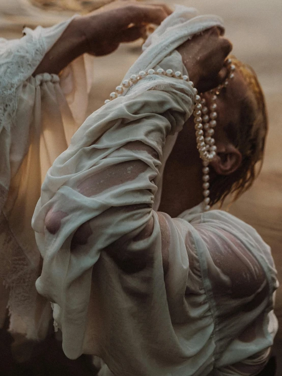 a woman in an old fashion outfit with her hair blown by the wind