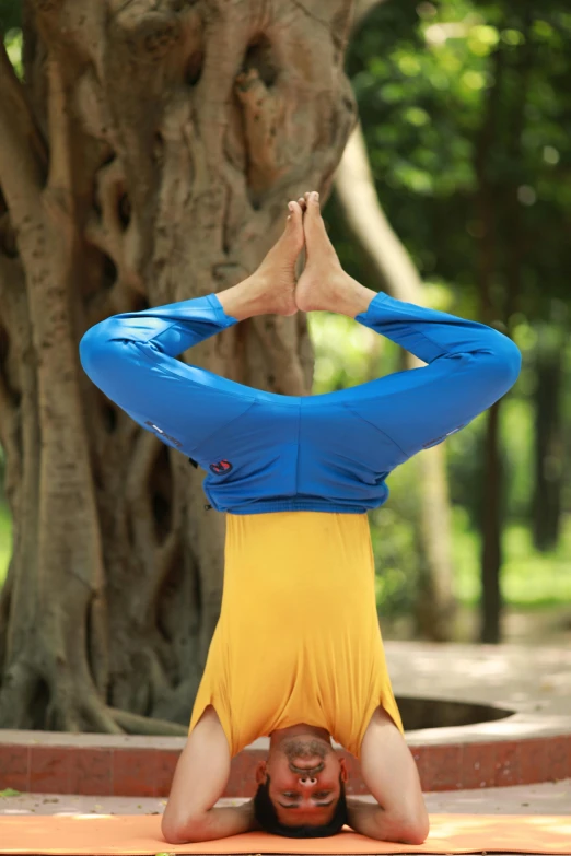 a man is upside down in the ground and doing yoga