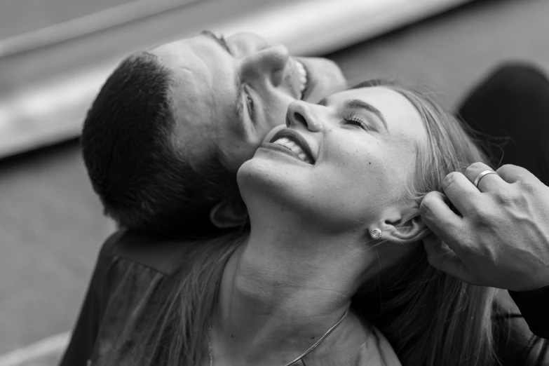 black and white image of a woman being helped up by an adult man