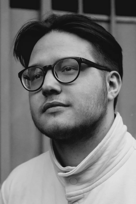 black and white po of a man with glasses