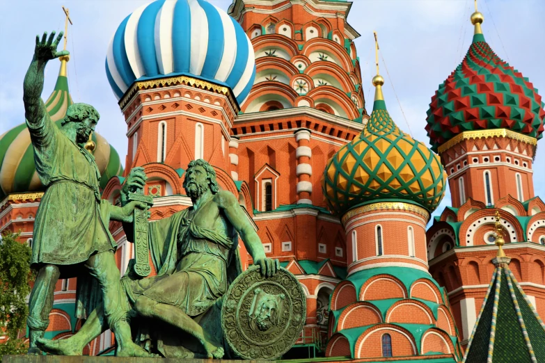 statues in front of an ornate, colorful building