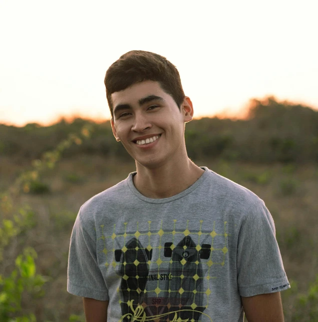 a boy posing with a frisbee on the ground