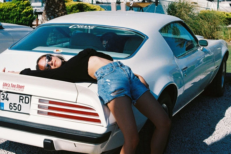 a person with their head out the window of a car