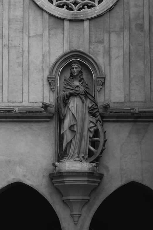 a sculpture on top of a building with arches