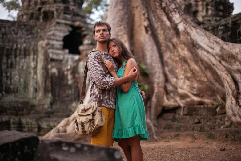 an engaged couple emcing in front of the tree of life at angahon ruins