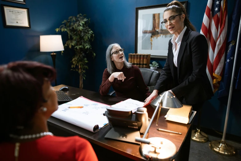 two women in an office with one pointing at a piece of paper